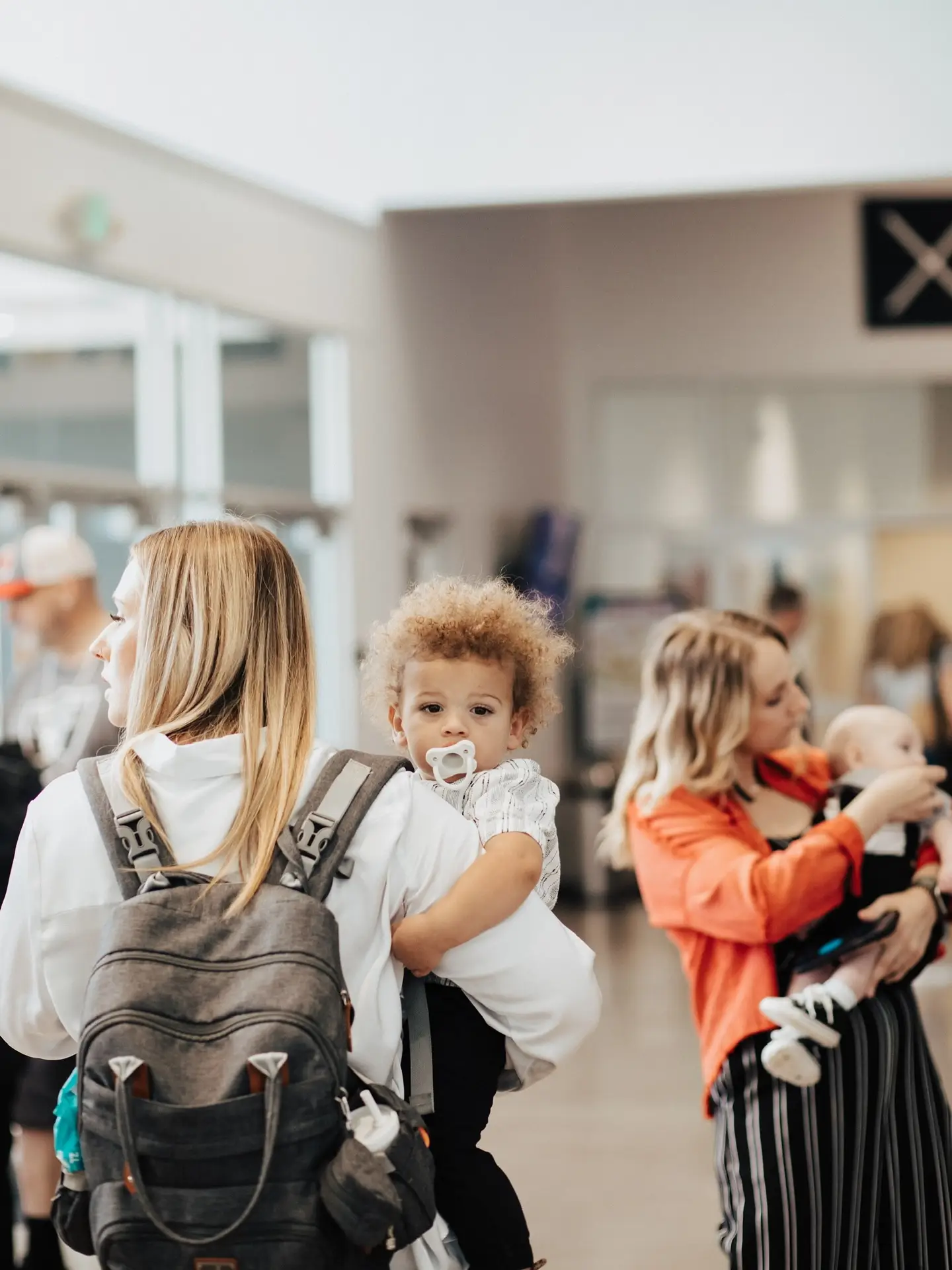 Parent holding child in X Kids environment